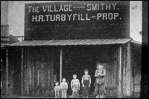 Primary view of object titled '[The Village Smithy - H.R. Turbyfill, Prop.]'.