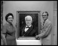 Photograph: [Johnnie Bell McDonald Ballard and Carl Avera beside painting of John…