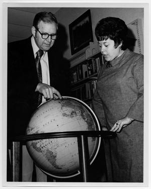 Primary view of object titled '[Man and Woman Examining a Globe]'.
