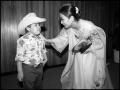 Photograph: [Miss Korea Speaking with a Young Boy]