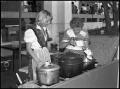 Photograph: [Two Women Cooking in Wendish Booth]