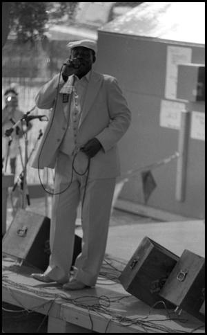 Primary view of object titled '[Big Roger Collins Performing at the Texas Folklife Festival]'.