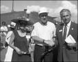 Photograph: [Two Men and a Woman at Opening Ceremony]