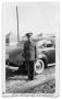 Photograph: Buddy Sinclair standing in uniform outside car