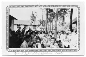 Primary view of object titled 'Large group of soldiers eating Camp Blandin 1942'.