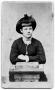 Photograph: [Young woman leaning on a pedestal]