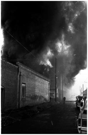 Primary view of object titled '[The Damron Hotel Fire, 17 of 21:   Two Individuals on the Street Northwest of the Fire]'.