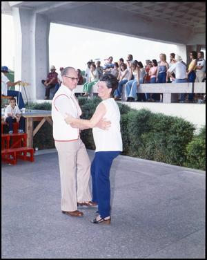 Primary view of object titled '[Jim and Mary Hebert Dancing While The Cajun Band Performs]'.