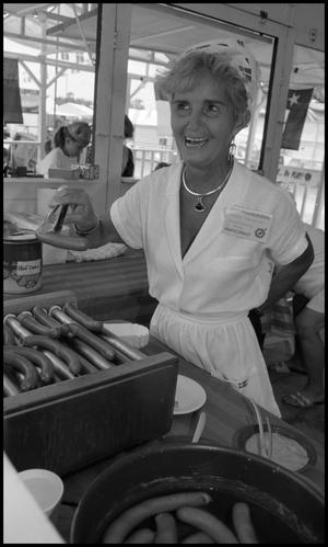 Primary view of object titled '[Grete Benedict selling hotdogs]'.