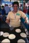 Primary view of [Woman Making Tortillas at the St. Timothy's Catholic Church Food Booth]