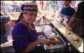 Photograph: [Woman serving tacos at the St. Alphonsus Catholic Church Food Booth]