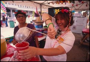 Primary view of object titled '[Aguas Frescas at the Mexican American Business and Professional Women Booth]'.