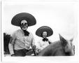 Photograph: [Two Men in Masks Riding Horses]