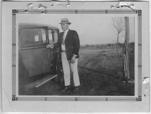 Primary view of object titled '[Walter Falls by an Automobile]'.