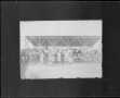 Primary view of [A baseball team standing in front of the covered grandstands.]