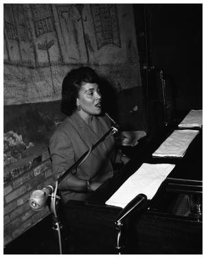 Primary view of object titled 'The New Orleans Club - exterior shot; interior shot - Ernie Mae Miller at the piano'.