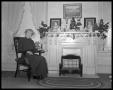 Photograph: [Mrs. Walter Bremond with Christmas decorations]