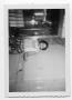 Photograph: Unidentified woman standing in a passageway