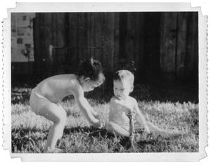 Ray Delphenis and another child playing with sprinklers