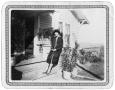 Photograph: Woman on the steps of a house