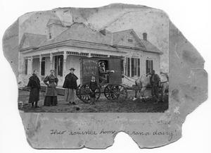 Primary view of object titled 'Theo Scrivner on a dairy wagon outside a home'.