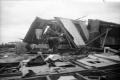Photograph: [Photograph of Man and Fallen House After Tornado]