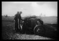 Thumbnail image of item number 1 in: '[Photograph of Men and Tornado-Damaged Vehicle]'.