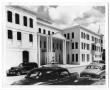 Photograph: [Cars in front of three-story building]