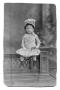 Photograph: [Child seated on a ledge]