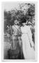 Primary view of [Two young women standing in yard]