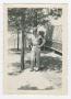 Photograph: [Military Policeman Leaning on Pine Tree]