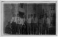 Photograph: [Group men standing in front of building-unidentified]