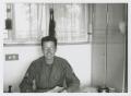 Photograph: [Soldier In Front of Windows]