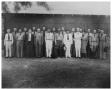 Photograph: [Twenty Men and One Woman in Front of  a Building]