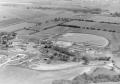 Photograph: [Early aerial with farmland at top of picture]