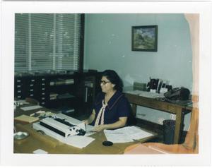 Primary view of object titled '[Secretary for Lignon Insurance Agency at work]'.