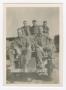 Photograph: [Five Soldiers Sitting on Top of a Jeep]