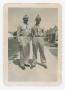 Photograph: [Dan Melli and Another Soldier Standing in Front of Tents]