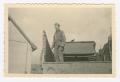 Photograph: [Elmer Heinlein Standing on the Bed of a Truck]
