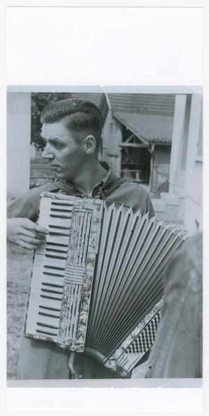 Primary view of object titled '[Soldier Playing a Captured Hohner Accordion]'.