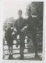 Photograph: [Two Soldiers and a Boy by a Bridge Railing]