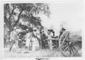 Photograph: [People Standing Near Covered Wagons]
