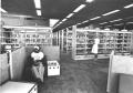 Photograph: [Library Shelves and Students]