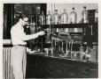 Thumbnail image of item number 1 in: '[Photograph of Student in Chemistry Lab]'.