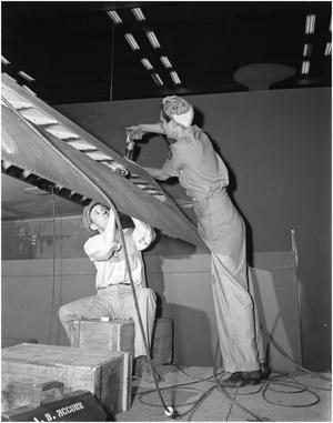 Primary view of object titled 'Man and Woman Riveting on Airplane Wing'.