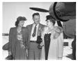 Photograph: [The Woodheads Standing Next to an Aircraft]