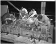 Photograph: [Four Men Working on the Nose of a Fuselage]