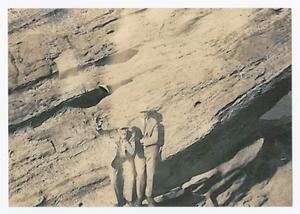 Primary view of object titled '[Two Men Standing Against Rock Wall at Lovers' Retreat]'.