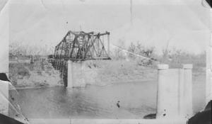 Primary view of object titled '[Construction of the Brazos River Bridge. Bridge is halfway across the river.]'.