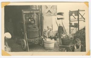 Primary view of object titled '[German Children Beside an Apple Press]'.